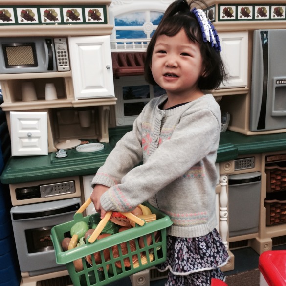 Roxy playing with the kitchen set in her classroom at Brookfield School. 