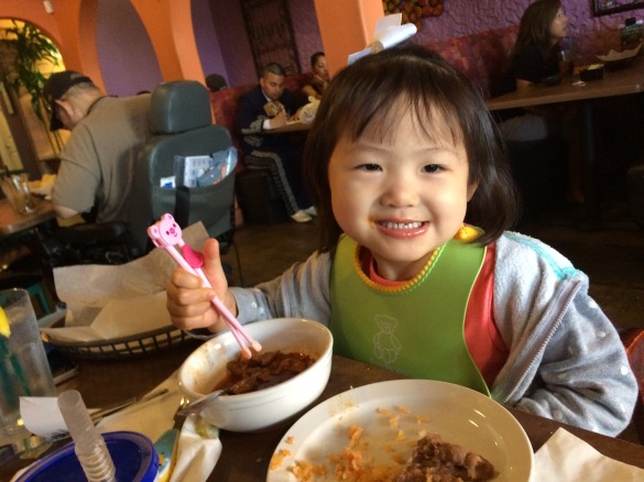 "Mama, I eat pozole with chopsticks!" Roxy has no idea why but I credit my Mexican god family for moments like this. 