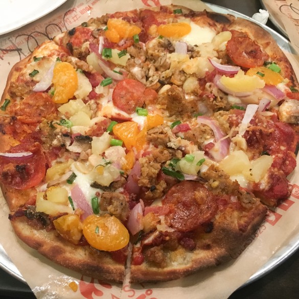 My pizza with spicy marinara, pepperoni, salami, sausage, linguisa, bacon, ham, shredded and fresh mozzarella, roasted garlic, red onion, tomatoes, mushrooms, green onion, mandarin oranges, pineapple, and parmesan cheese