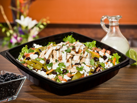 Hatch Chile Chicken Salad with lime-marinated, chargrilled chicken breast on top of hand-cut greens with feta cheese, diced tomatoes, carrots, black beans, chargrilled sliced Hatch chiles and fresh cilantro, tossed in our house-made cilantro lime ranch dressing