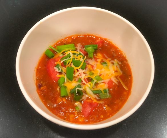 Turkey Taco Chili topped with tomatoes, green onion, and shredded cheese 
